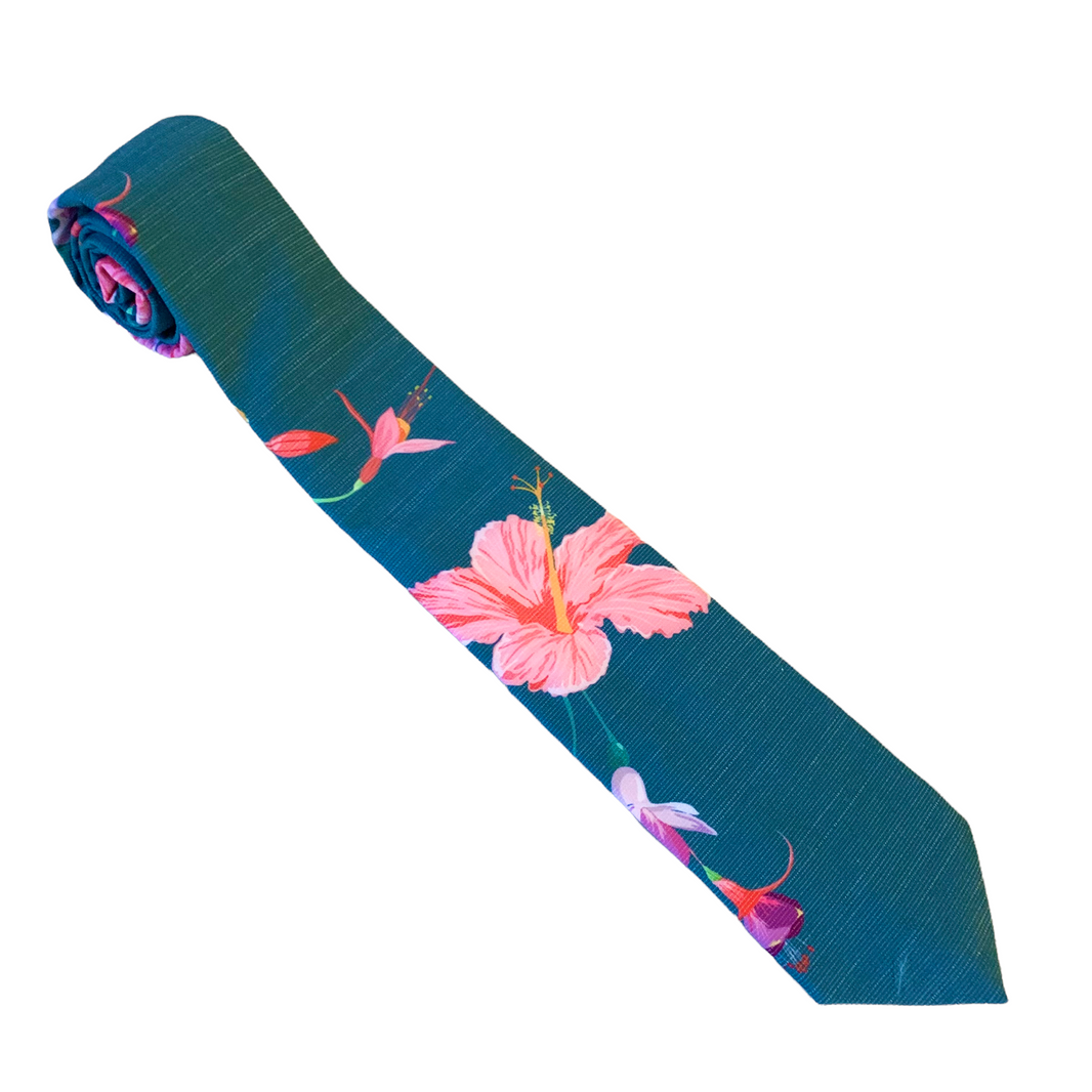 A teal necktie with tropical floral pattern, Tie for men in Cache Valley – refined Utah style made by Kator Shop for the perfect finishing touch.