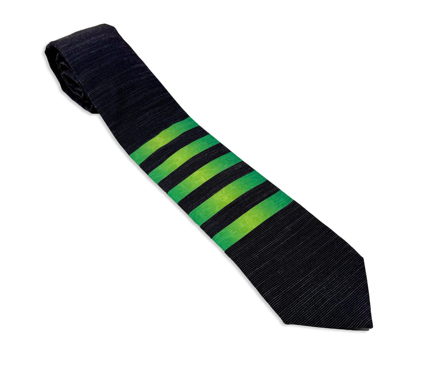 A striped green men's necktie with the pattern of water ripples in the stripes Tie from Kator Shop in Logan, Utah – high-quality men’s accessory made for timeless style and confidence.
