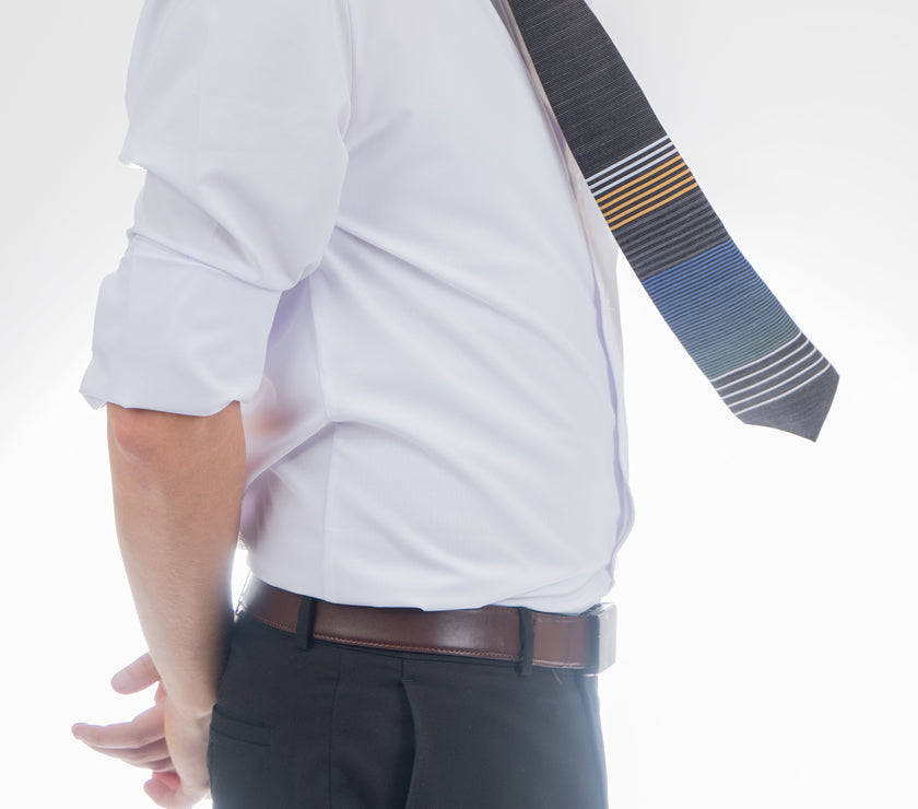 A man wearing a cool, modern, striped blue and yellow necktie. Missionary Tie handcrafted by Kator Shop – refined Utah menswear piece built to elevate any formal look in Cache Valley.