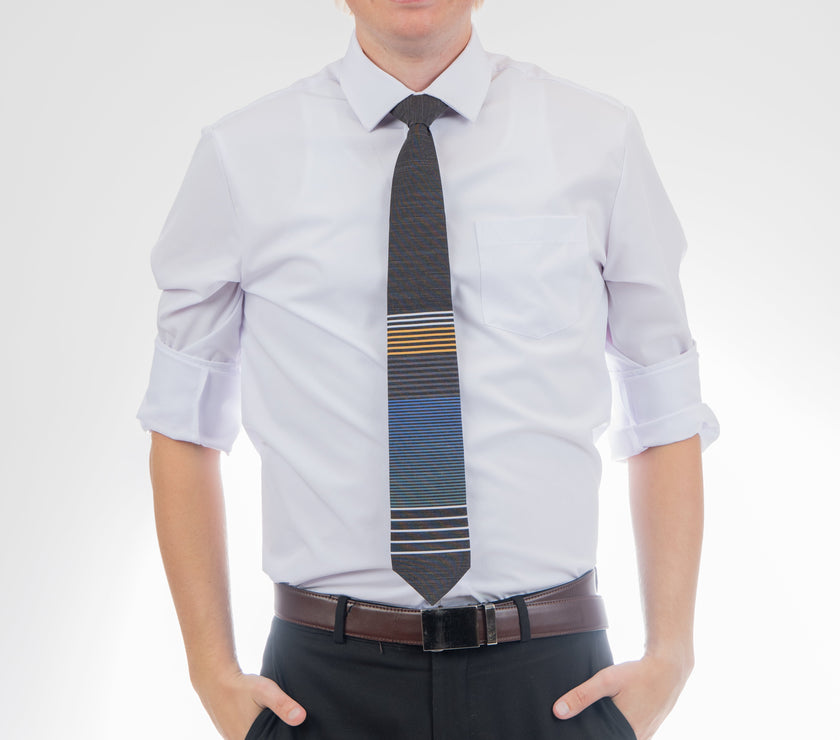 A man wearing a cool, modern, striped blue and yellow necktie. Tie for men in Cache Valley – refined Utah style made by Kator Shop for the perfect finishing touch.