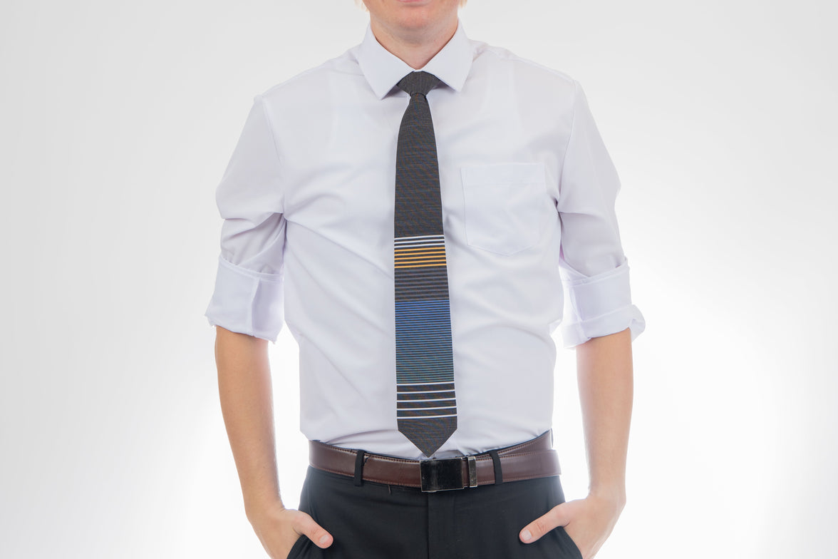 A man wearing a cool, modern, striped blue and yellow necktie. Tie for men in Cache Valley – refined Utah style made by Kator Shop for the perfect finishing touch.