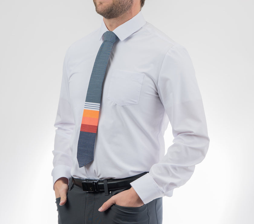 Man wearing a modern, colorful, cool necktie with thick, color blocked stripes of yellow, peach, and red