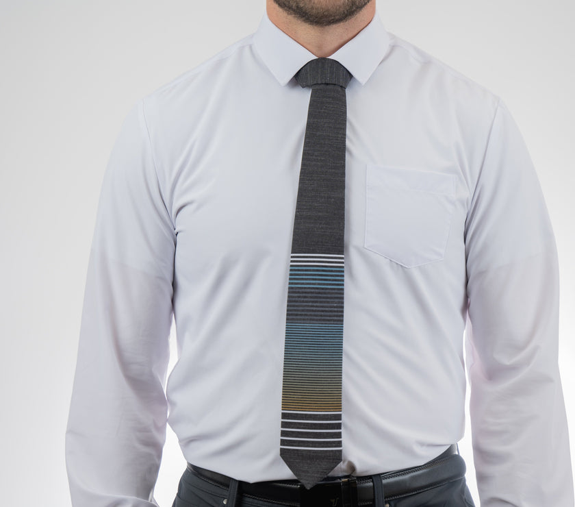A man wearing a cool, modern, striped blue and yellow necktie