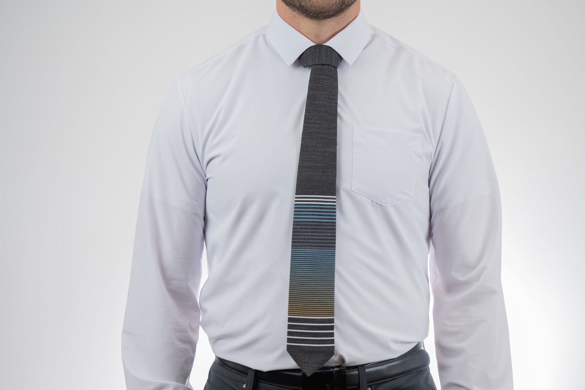 A man wearing a cool, modern, striped blue and yellow necktie