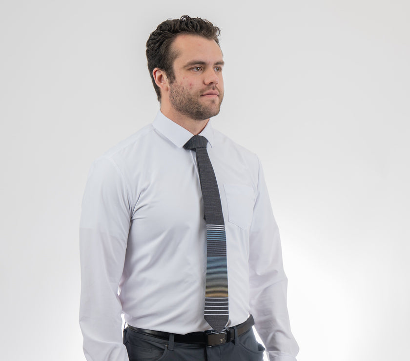 A man wearing a cool, modern, striped blue and yellow necktie