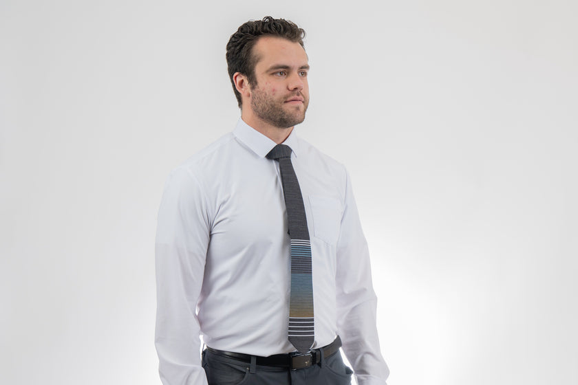 A man wearing a cool, modern, striped blue and yellow necktie