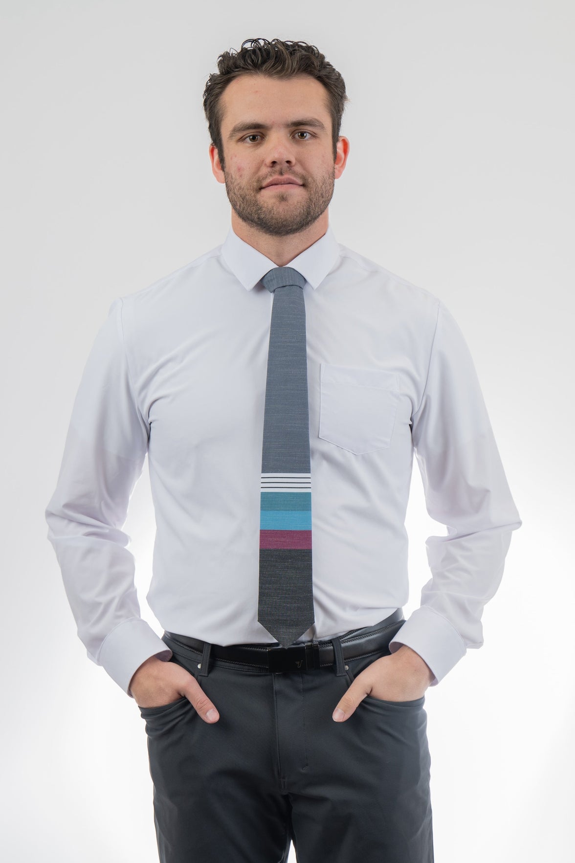 A man wearing a cool, modern necktie with thick purple, green, turquoise stripes