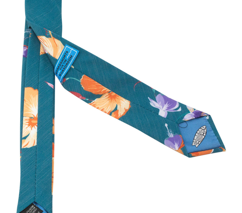A teal necktie with tropical floral pattern, Tie featuring rich color and premium stitching – Kator Shop’s high-end accessory for men in Utah.