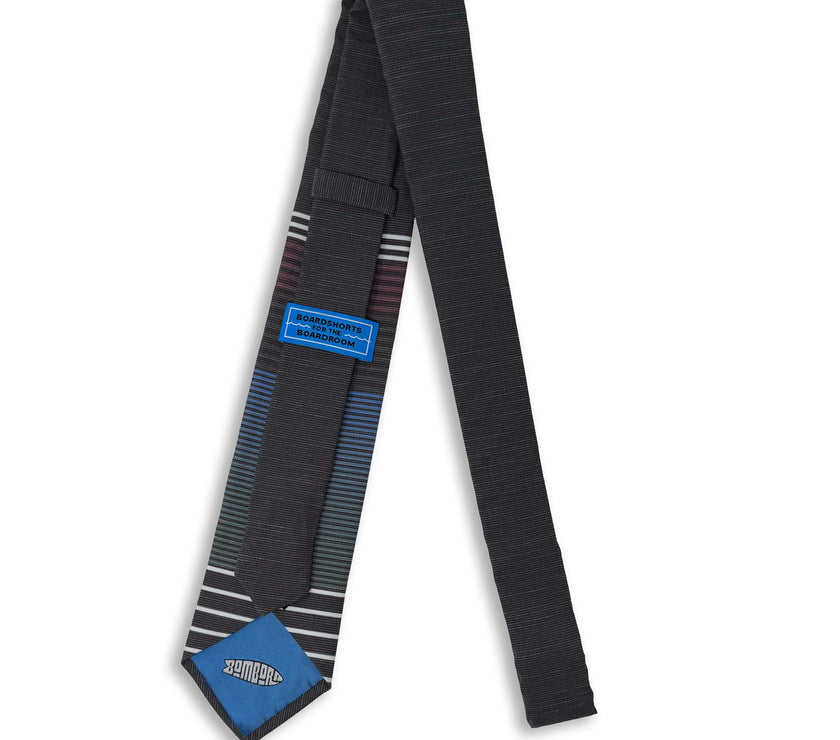 Photo of the back of a man's necktie with the tiekeeper and tipping