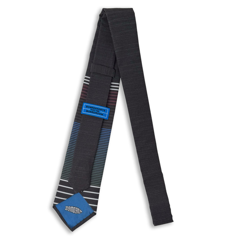 Photo of the back of a man's necktie with the tiekeeper and tipping
