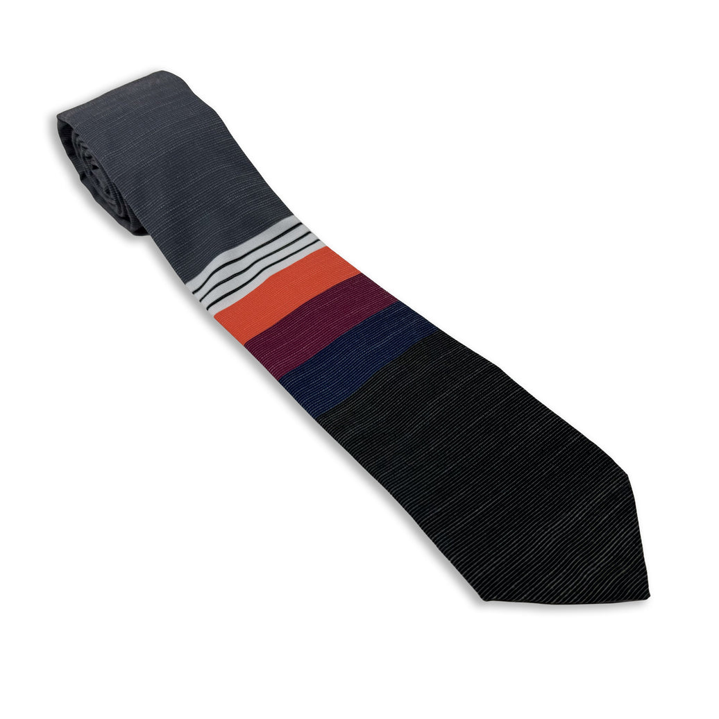 A cool, modern necktie with thick coral, purple, and blue stripes