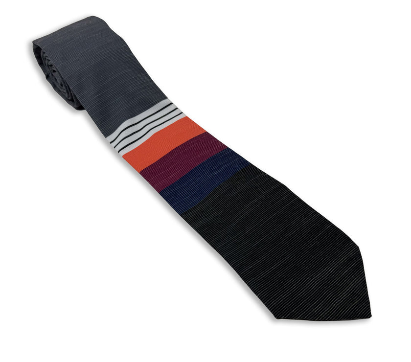 A cool, modern necktie with thick coral, purple, and blue stripes