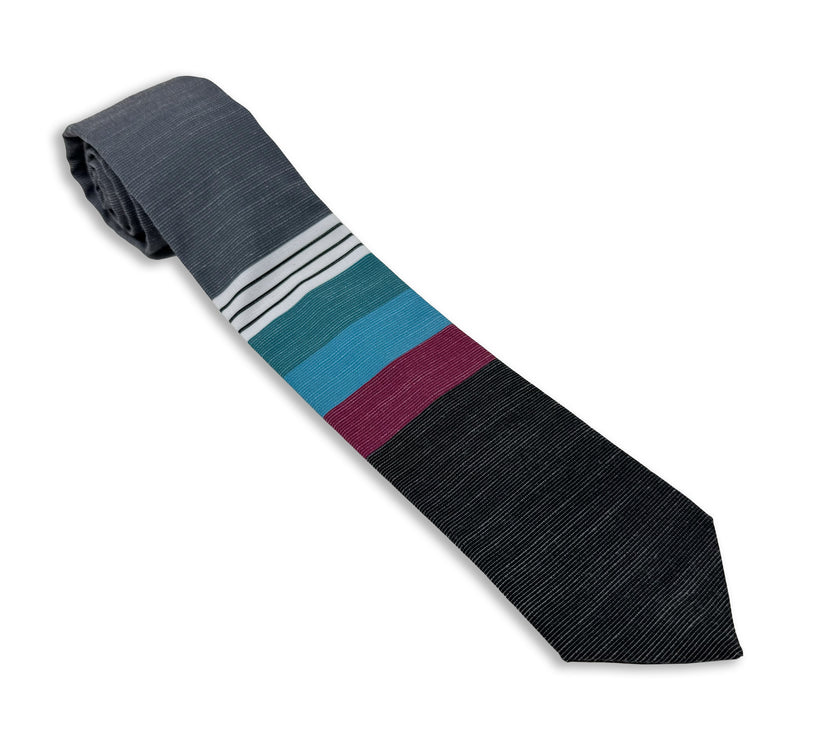 A cool, modern necktie with thick purple, green, turquoise stripes