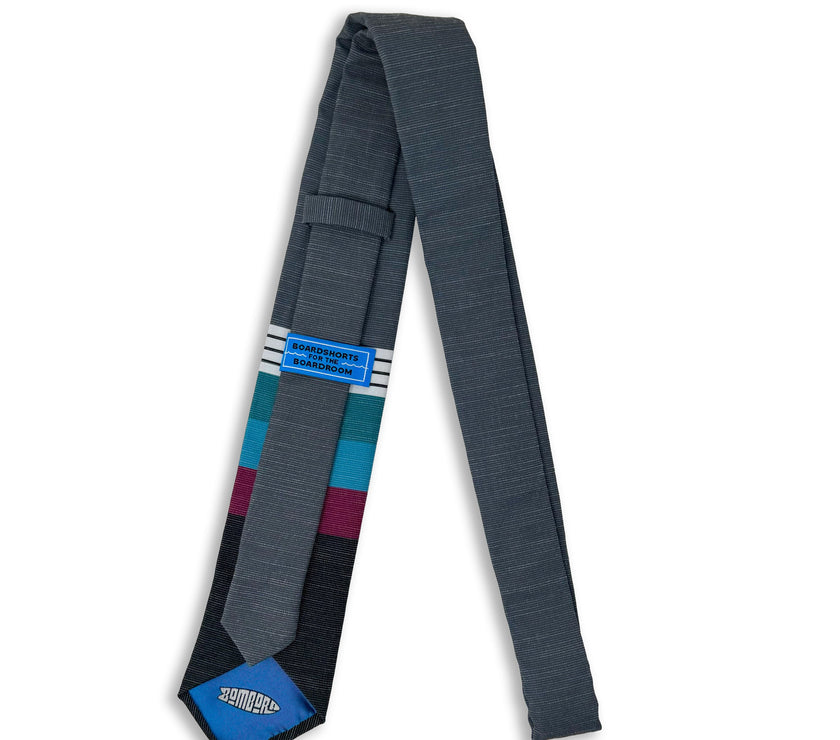 A cool, modern necktie with thick purple, green, turquoise stripes