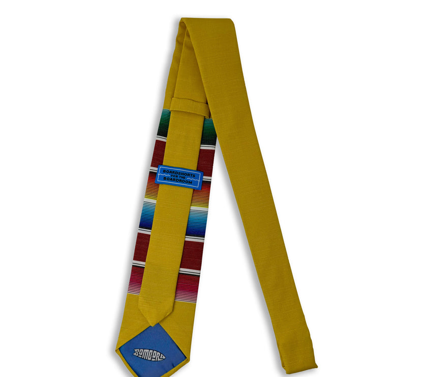 A fun, yellow necktie with multicolored stripes in the style of a Mexican blanket