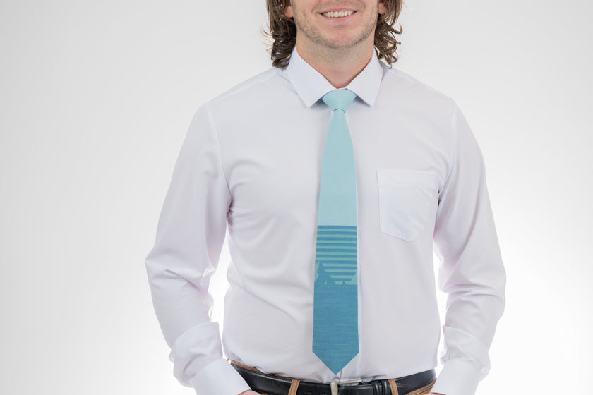 Man wearing a turquoise mountain tie with stripes. Premium tie from Kator Shop in Cache Valley — thoughtful Utah gift for birthdays, missions, or holidays.