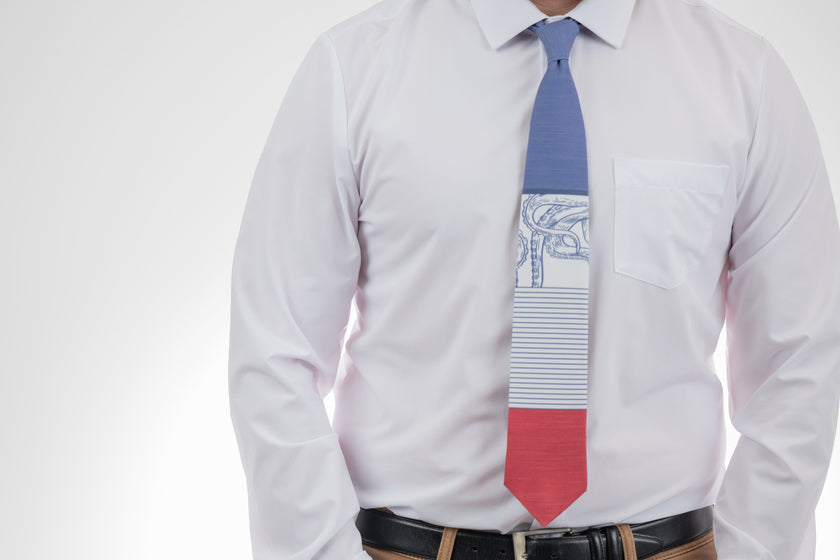 A man wearing a blue, white, and red necktie with stripes and an octopus on it.Business tie from Kator Shop in Logan, Utah — premium material designed for confidence and all-day comfort at work.