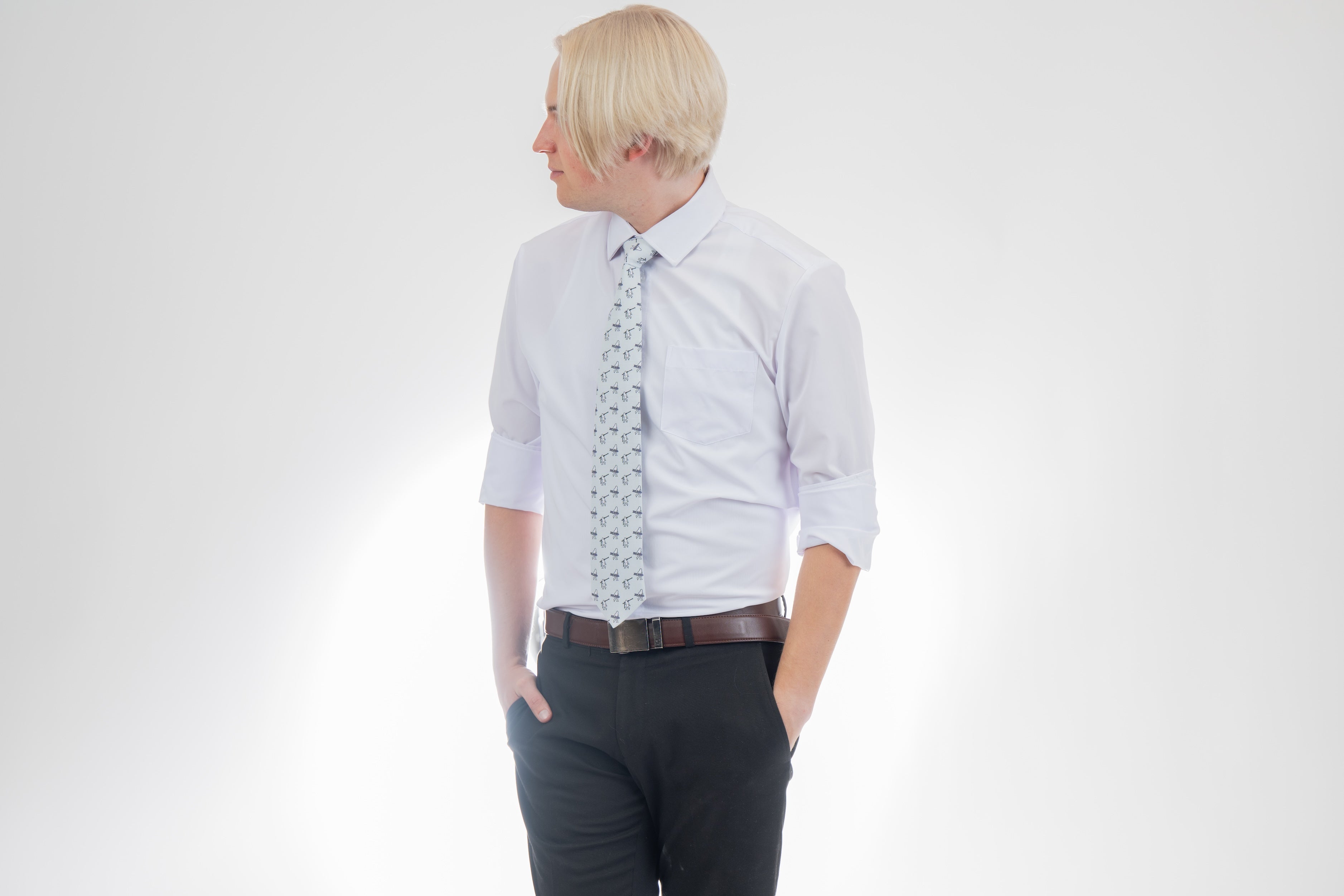 A man wearing a necktie with yetis, skis, and snowboards. Premium tie from Kator Shop in Cache Valley — thoughtful Utah gift for birthdays, missions, or holidays.