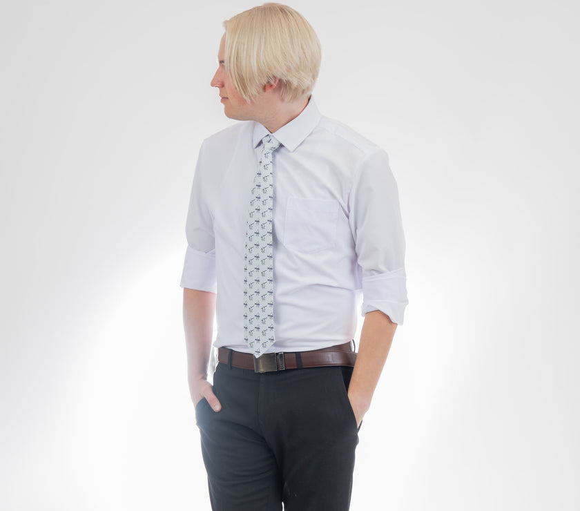 A man wearing a necktie with yetis, skis, and snowboards. Premium tie from Kator Shop in Cache Valley — thoughtful Utah gift for birthdays, missions, or holidays.