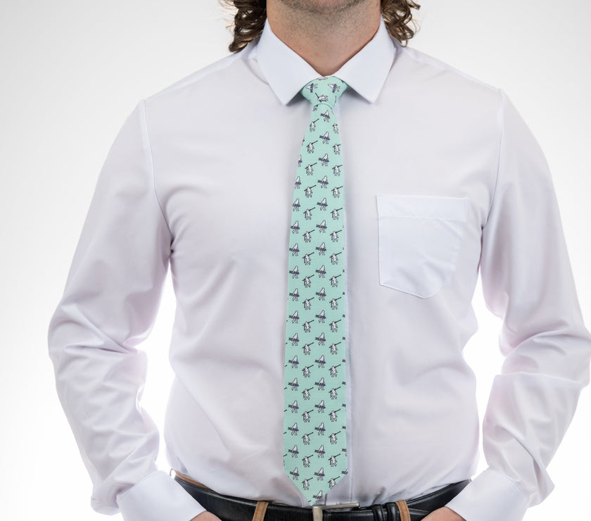 A necktie with yetis, skis, and snowboarding