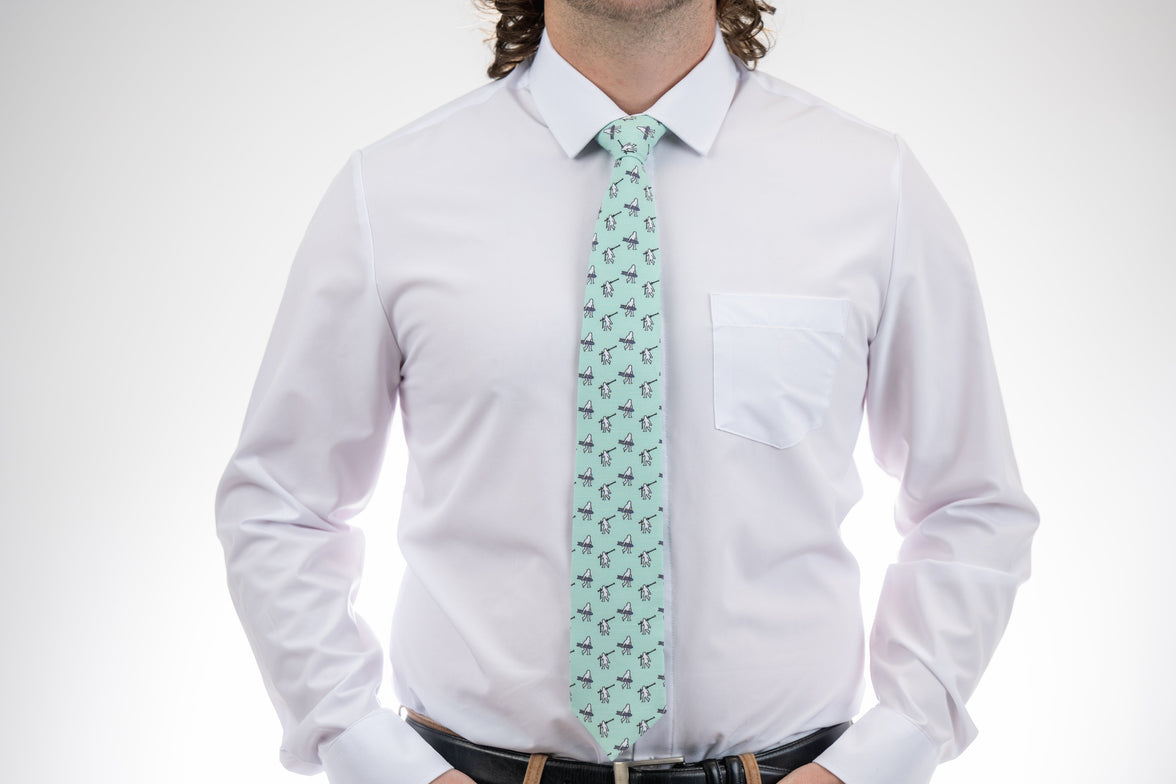 A necktie with yetis, skis, and snowboarding