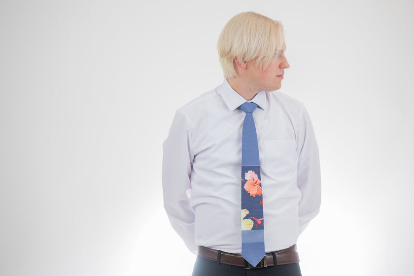 Sky Hibiscus Panel Men's Tie. Man wearing a modern, tropical floral necktie. Business tie handcrafted in Logan, Utah — premium material and clean lines for confident everyday office wear.