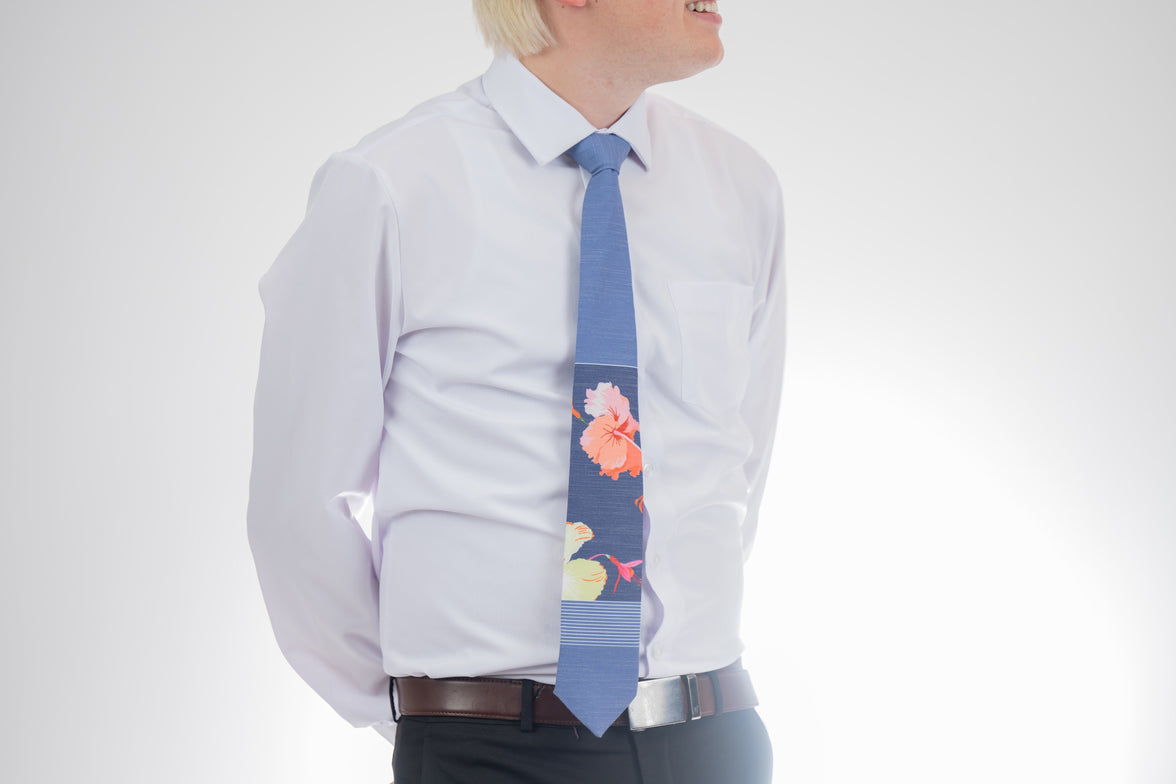 Sky Hibiscus Panel Men's Tie. Man wearing a modern, tropical floral necktie. Gift-ready tie from Kator Shop in Cache Valley — ideal Utah gift for missions, graduations, or Father’s Day.