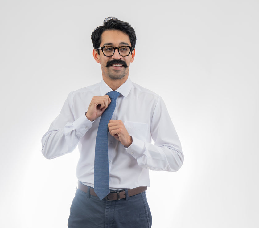 Man wearing a cool, modern, blue necktie. Elegant wedding tie from Kator Shop — designed in Utah for timeless wedding style that photographs perfectly.