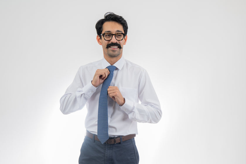 Man wearing a cool, modern, blue necktie. Elegant wedding tie from Kator Shop — designed in Utah for timeless wedding style that photographs perfectly.