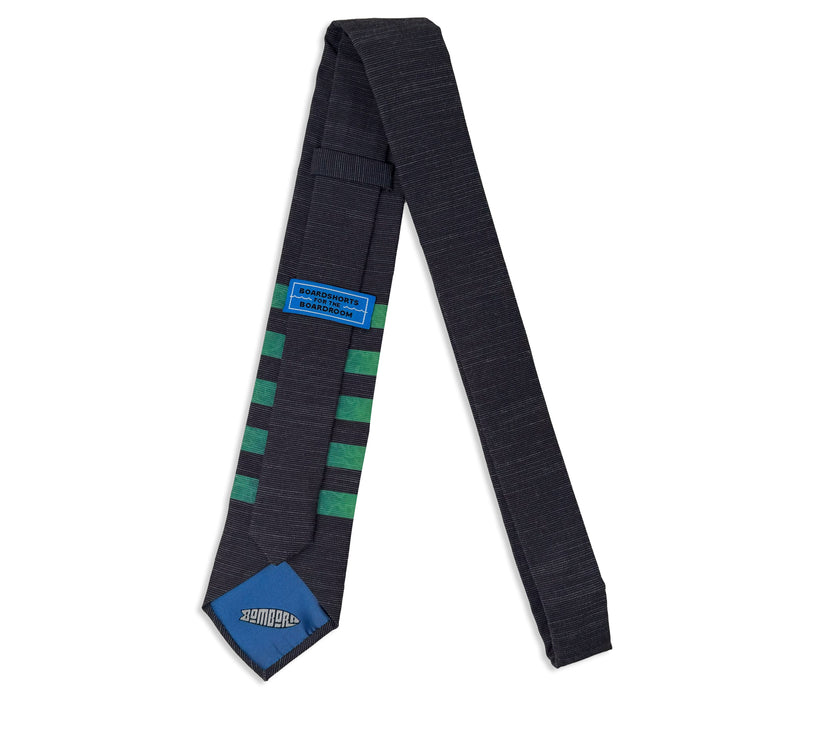 The back of a striped green men's necktie, showing the tiekeeper loop and the tipping Tie designed by Kator Shop – elegant men’s fashion accessory bringing quality and comfort to Utah style.